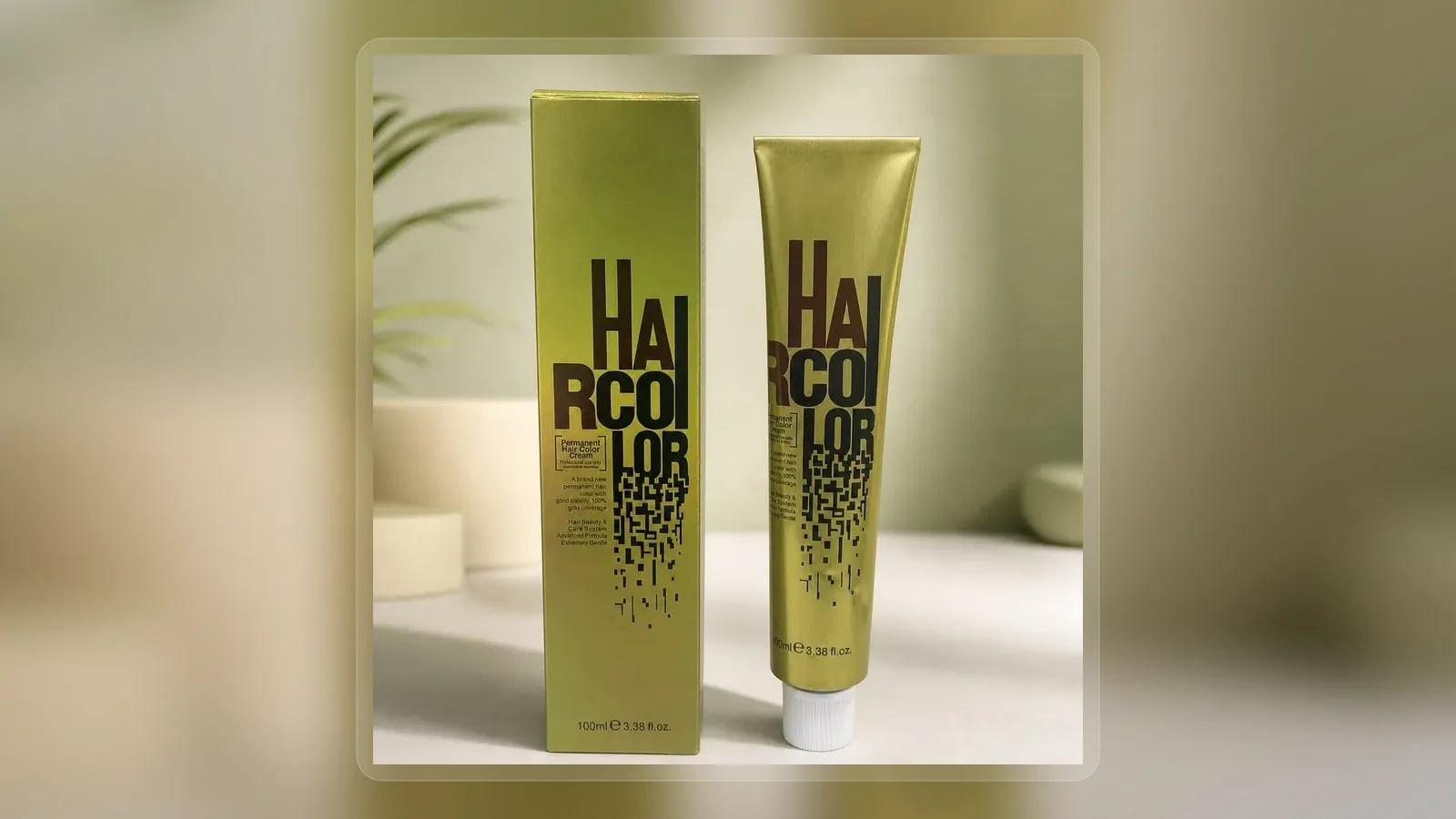 Metallic hair dye tube standing beside green carton in wide presentation layout