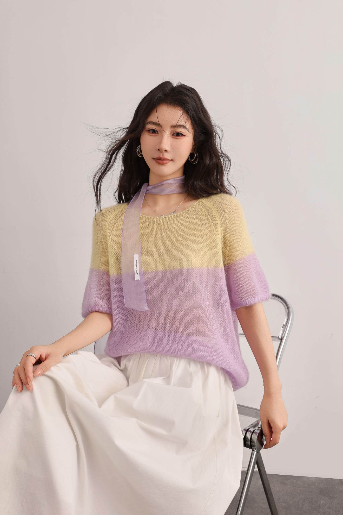 White background product photo of a fine gauge knitted base top