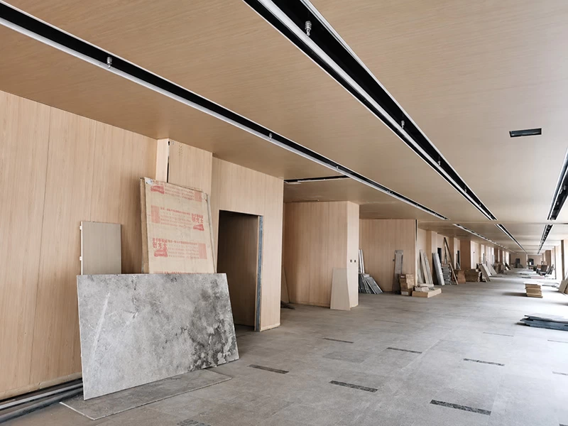 Wood-grain aluminum panels installed across interior walls and ceiling