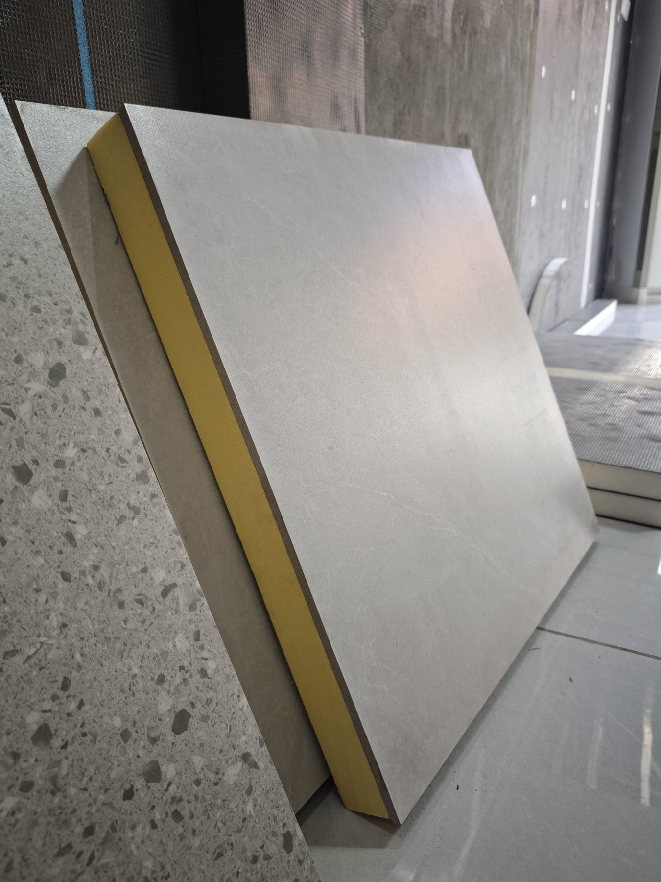 Integrated insulated tile board front and back surfaces