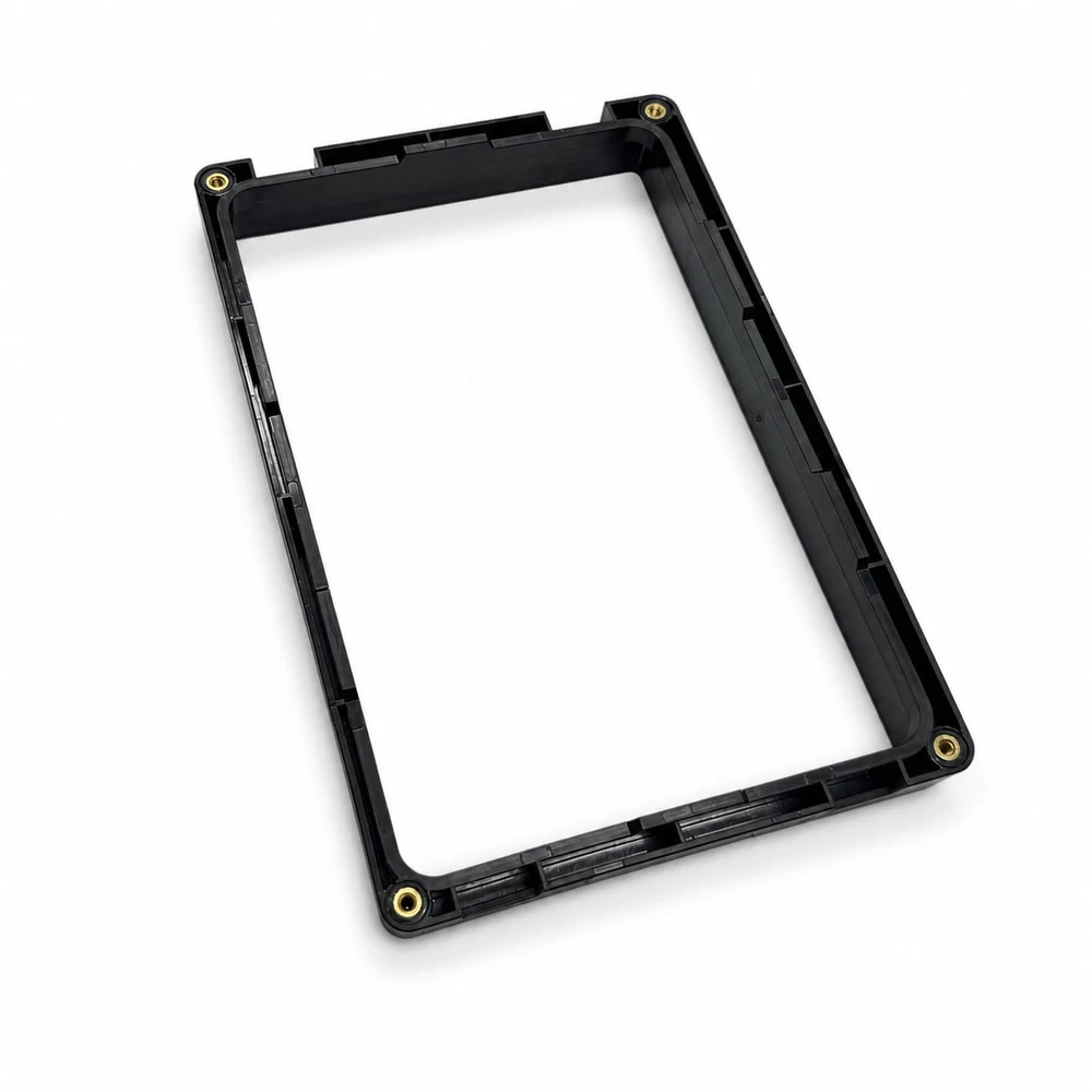 Black medical equipment display bezel with large rectangular opening