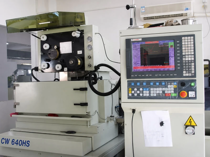 Wire-cut EDM machine producing precision mold components at Hengmei Plastic Products
