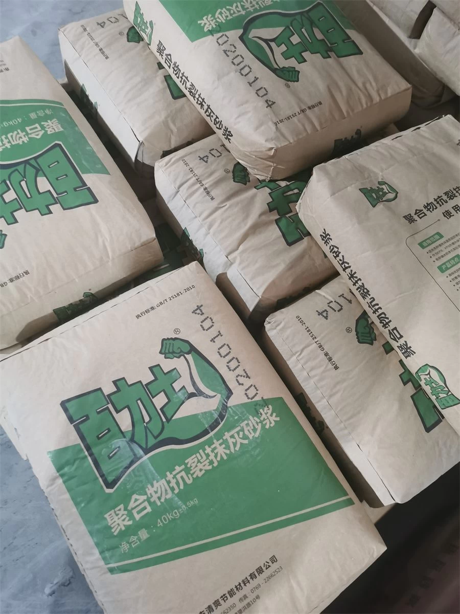 Green bags of polymer anti-crack plastering mortar in storage