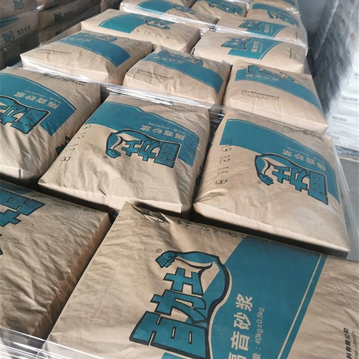 Blue bags of sound insulation mortar stacked for project delivery square primary view