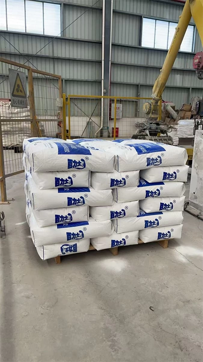 Stacked white bags of thermal insulation gel inside a factory