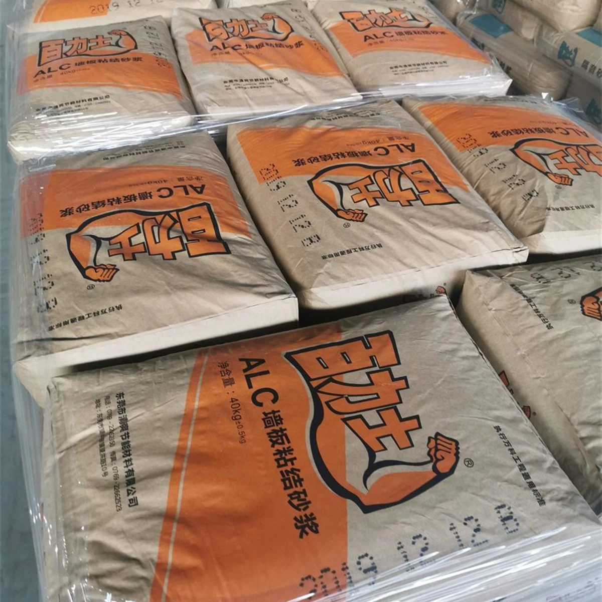 Bags of ALC wall panel adhesive mortar stacked for shipment square primary view