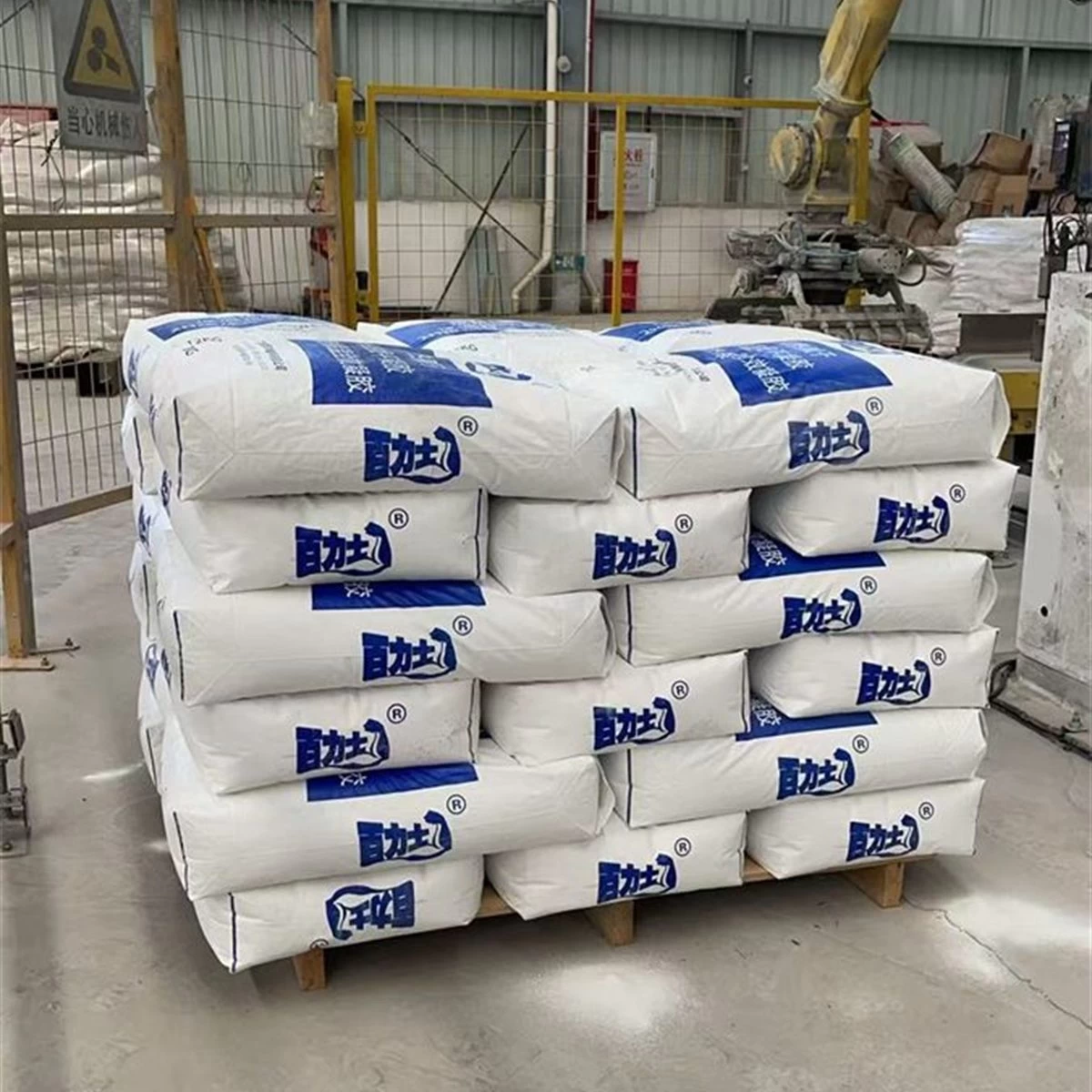 Stacked white bags of thermal insulation gel inside a factory square primary view
